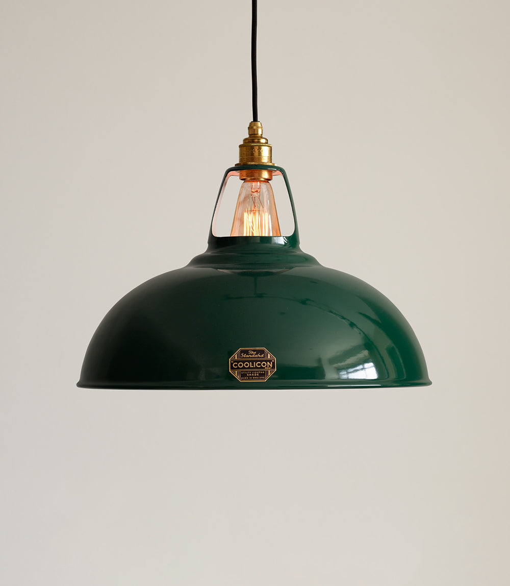 A Large Original Green lampshade  hanging over a cream background