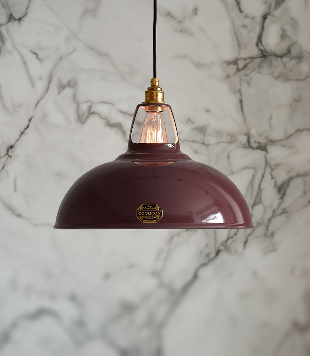 A Large metropolitan lampshade hanging over a cream background