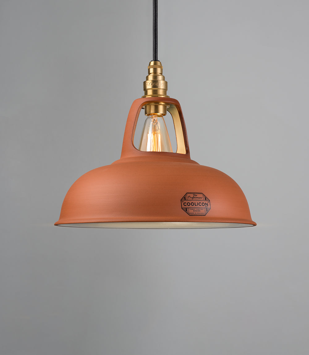 A Natural Terracotta shade hanging over a grey background