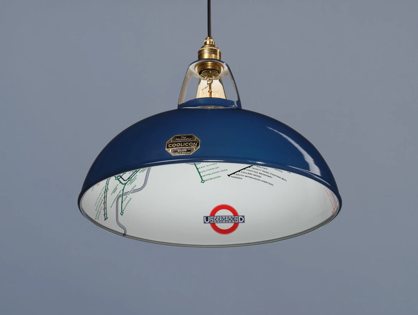 A Large Piccadilly Line Blue shade hanging over a blue background