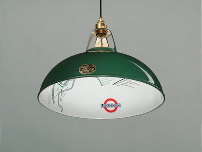 A Large District Line Green shade hanging over a light green background