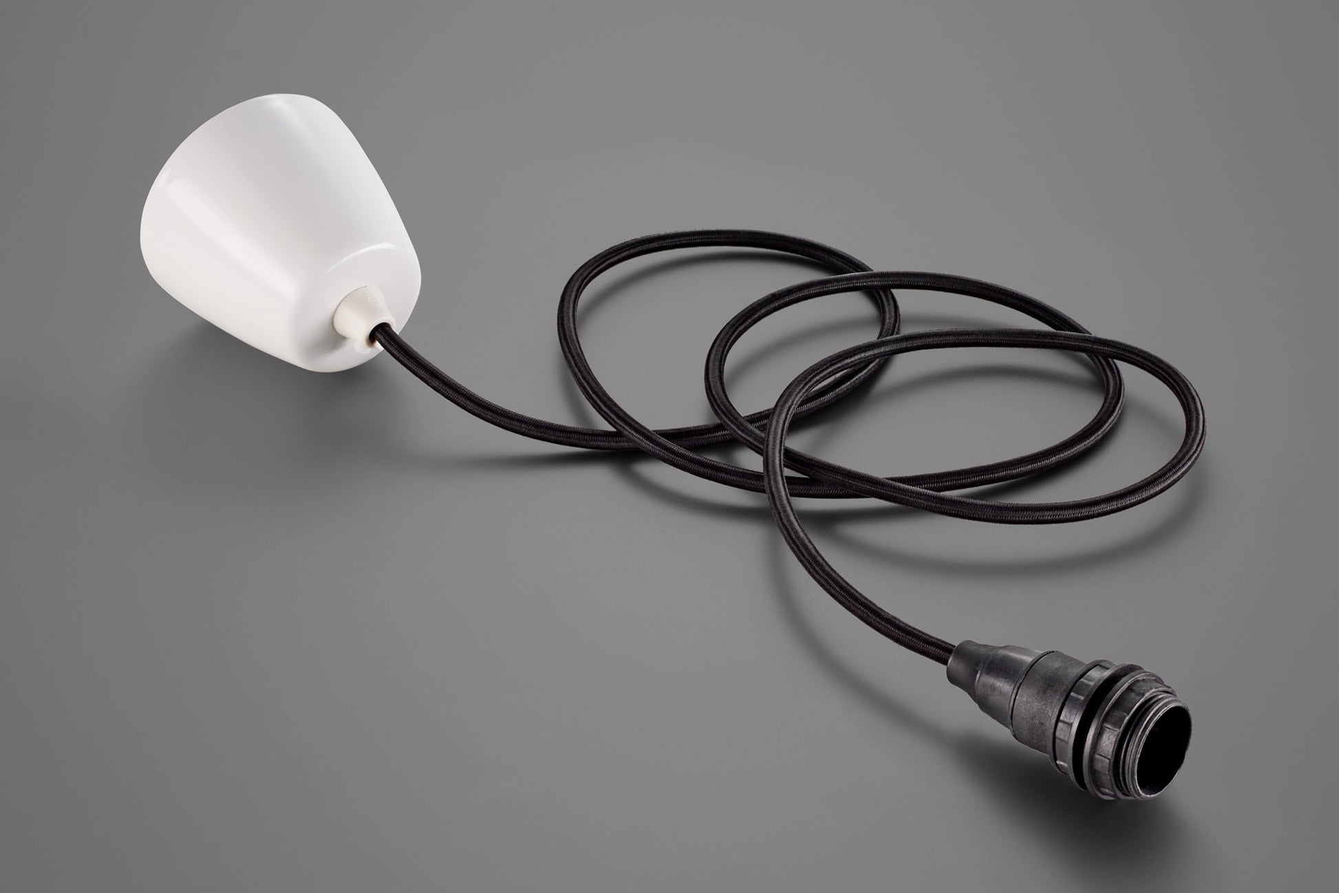 A Coolicon Industrial Bakelite pendant set with a white Vitreous Enamel ceiling cup and black cable