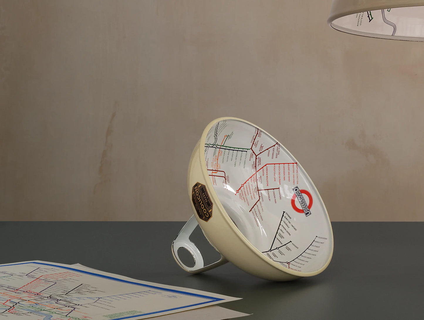 An Original Paper Cream shade on a table. There are a couple of printed 1933 maps on the left